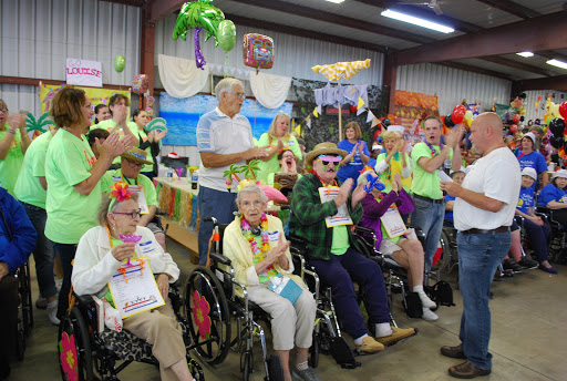 A lively community event featuring seniors enjoying the festivities with colorful costumes and decorations.
