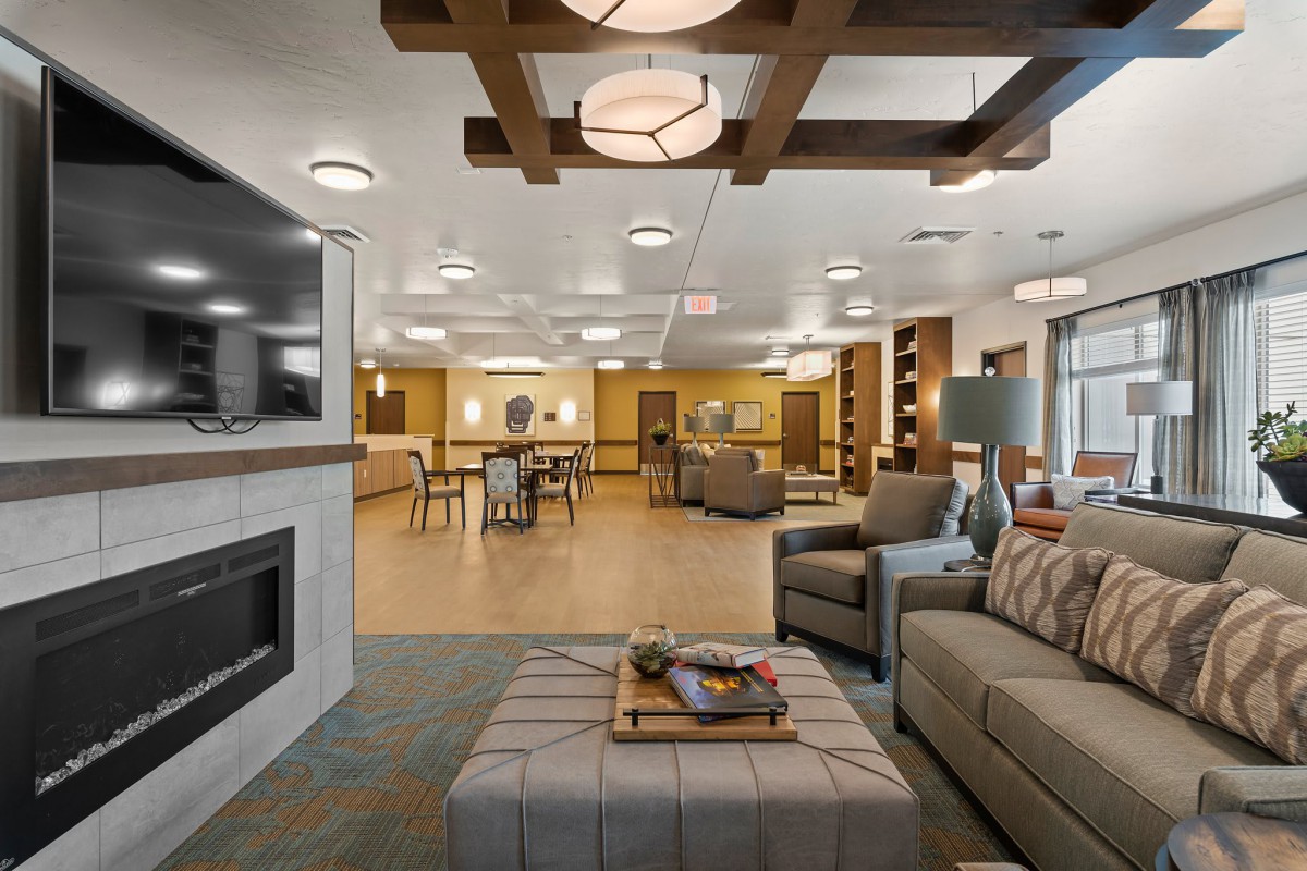 A modern and cozy living room with comfortable seating and a fireplace.