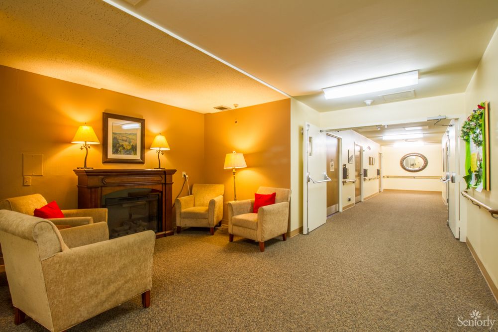 A warmly lit lobby area with comfortable seating and a fireplace.