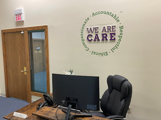 An inviting office space featuring a motivational wall art that emphasizes care and accountability.