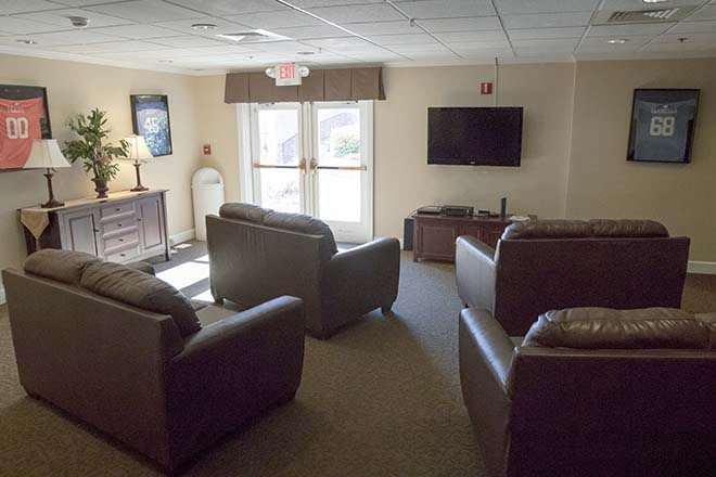 A cozy living room with comfortable sofas facing a mounted television.