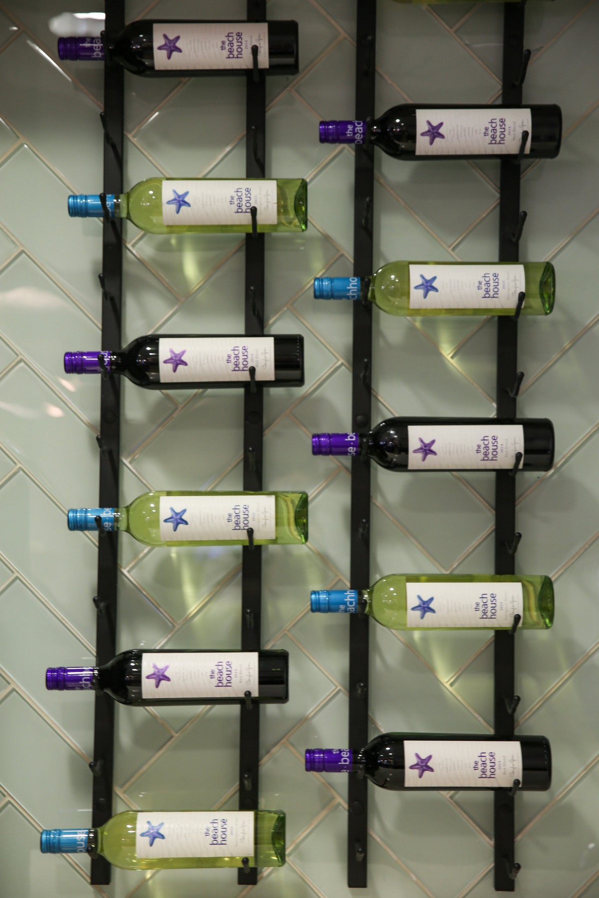 A neatly arranged display of wine bottles on a rack.
