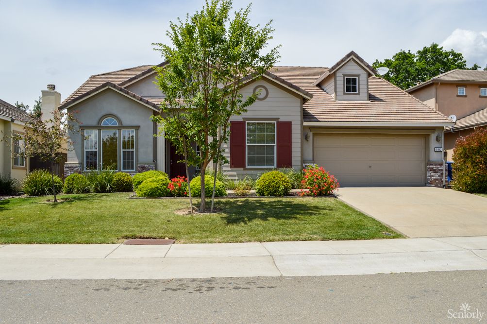 A suburban house with a well-maintained front yard and driveway.