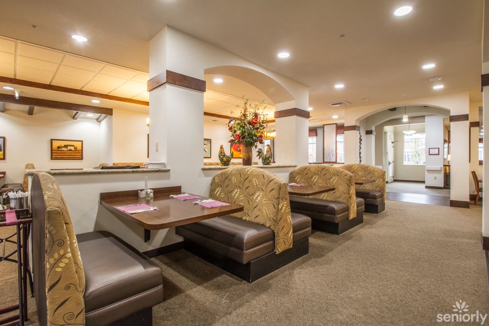 A cozy restaurant interior featuring booth seating and warm lighting.