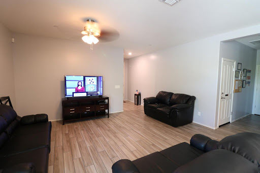 A cozy living room featuring a television and comfortable seating.