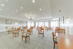 A spacious and bright dining room with neatly arranged chairs and tables.