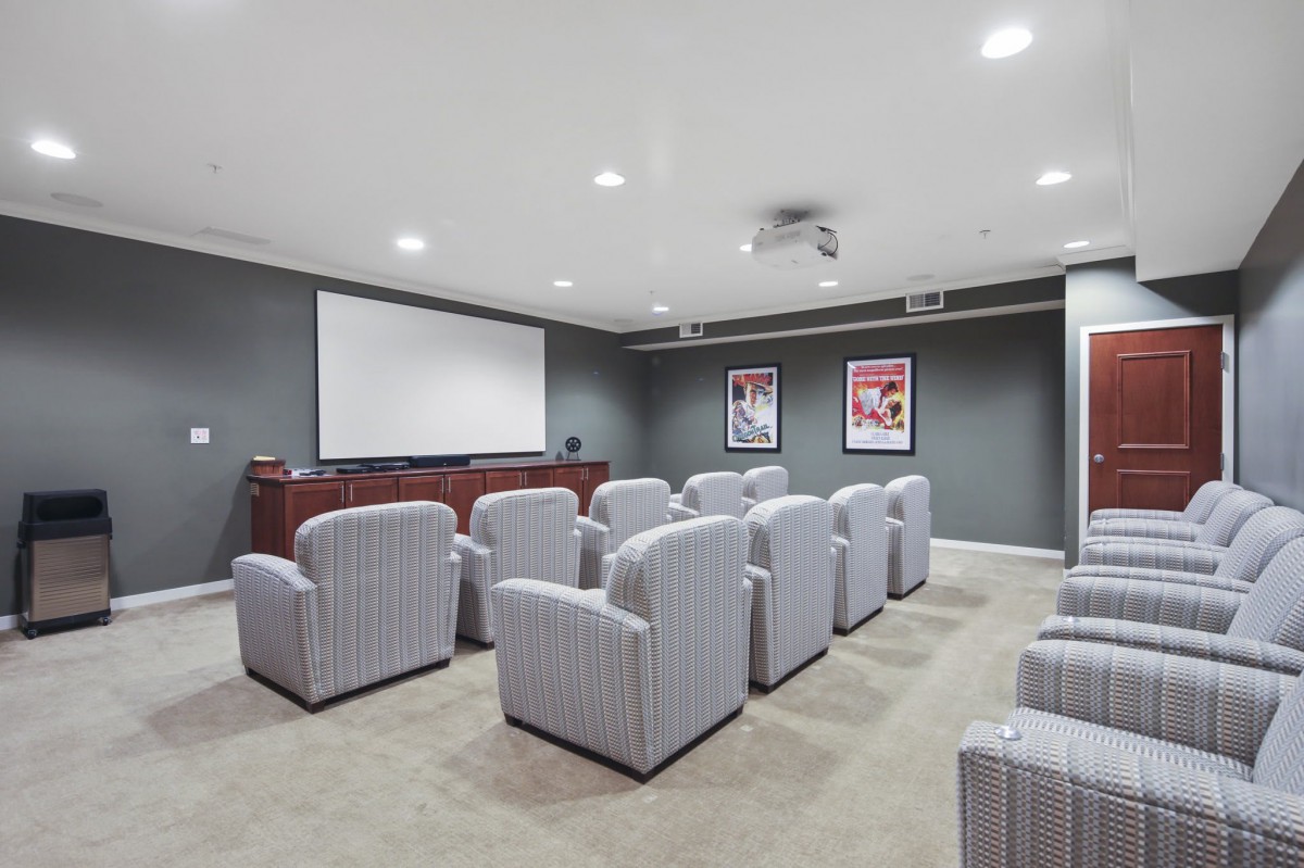 A home theater room with comfortable seating and a large screen.