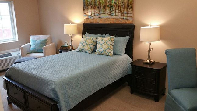A cozy bedroom with a neatly made bed, soft lighting, and stylish decor.