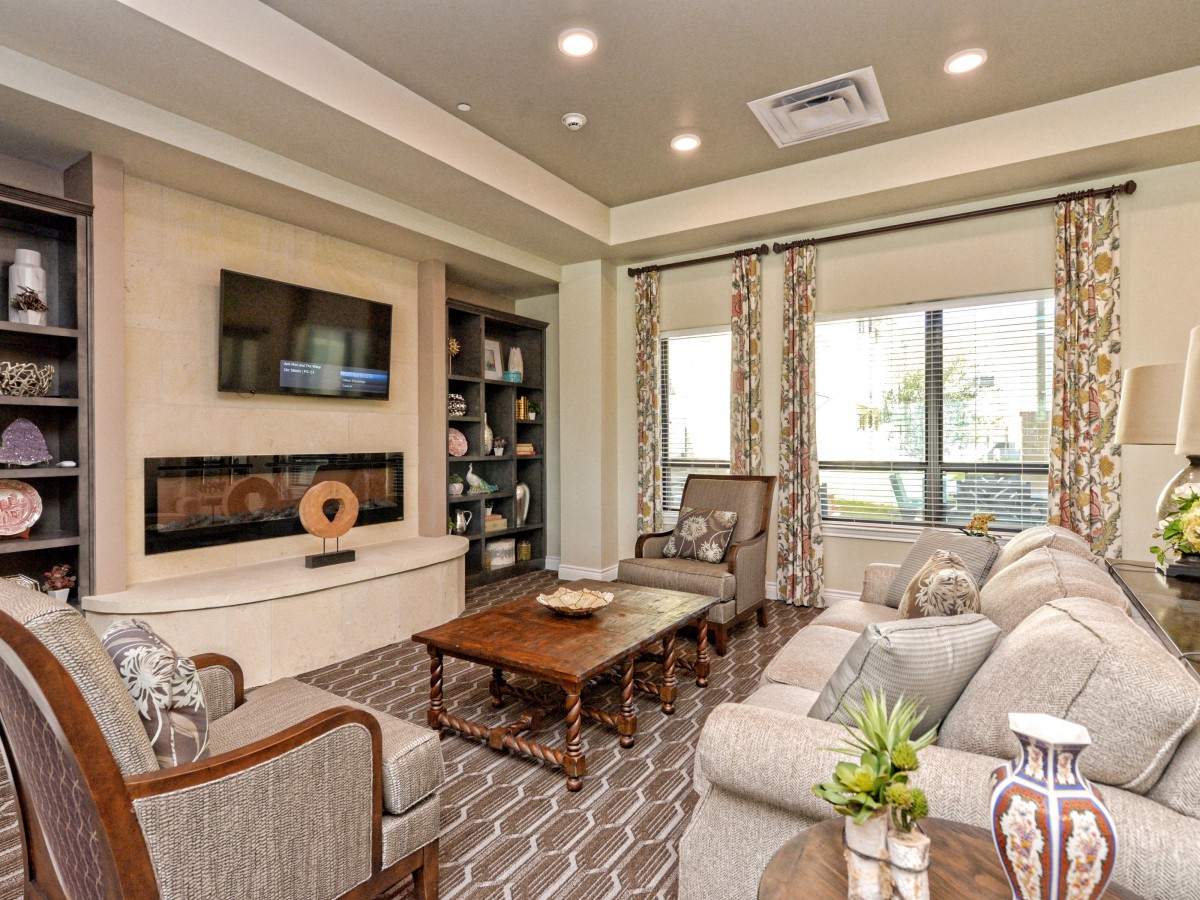 A modern living room with comfortable seating, a coffee table, and a mounted television.