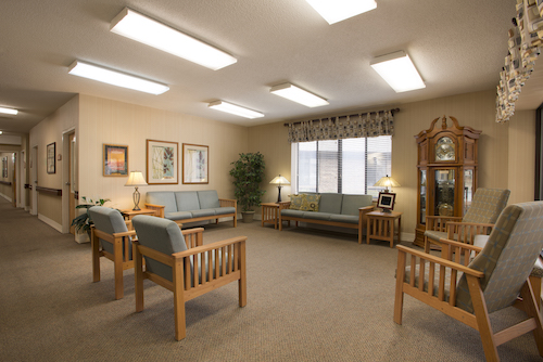 A cozy waiting room featuring comfortable seating and warm lighting.