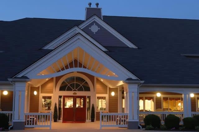 A warmly lit building entrance during the evening hours.