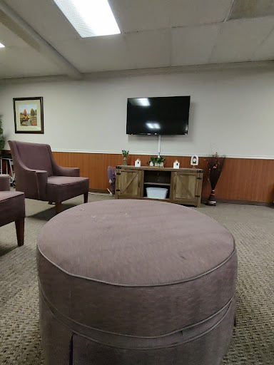 A cozy living room setup featuring comfortable chairs and a television.