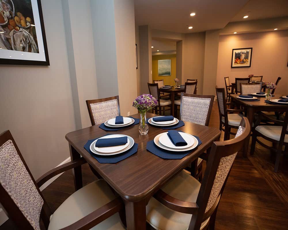 An elegantly set dining table in a cozy restaurant setting.