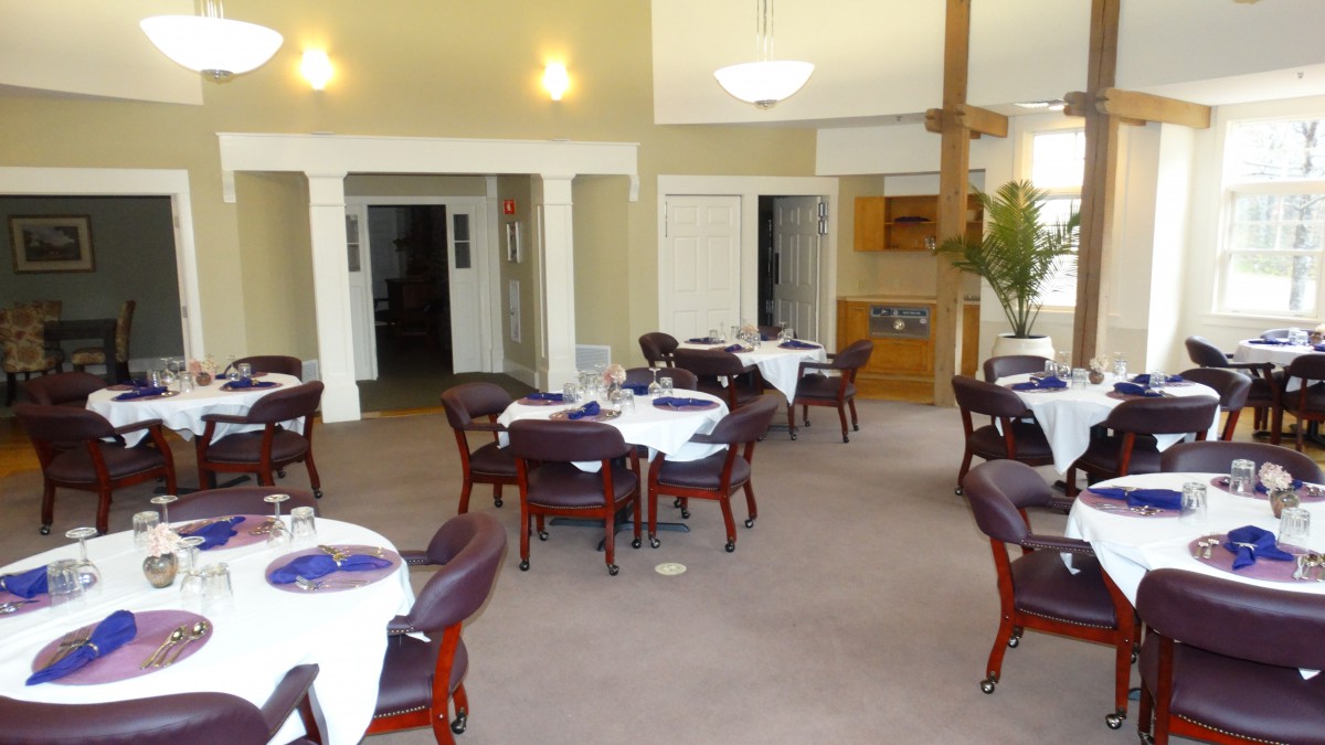 A neatly arranged dining area with tables and chairs in a restaurant setting.