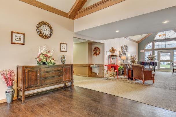 A cozy living room interior with wood flooring and decorative elements.