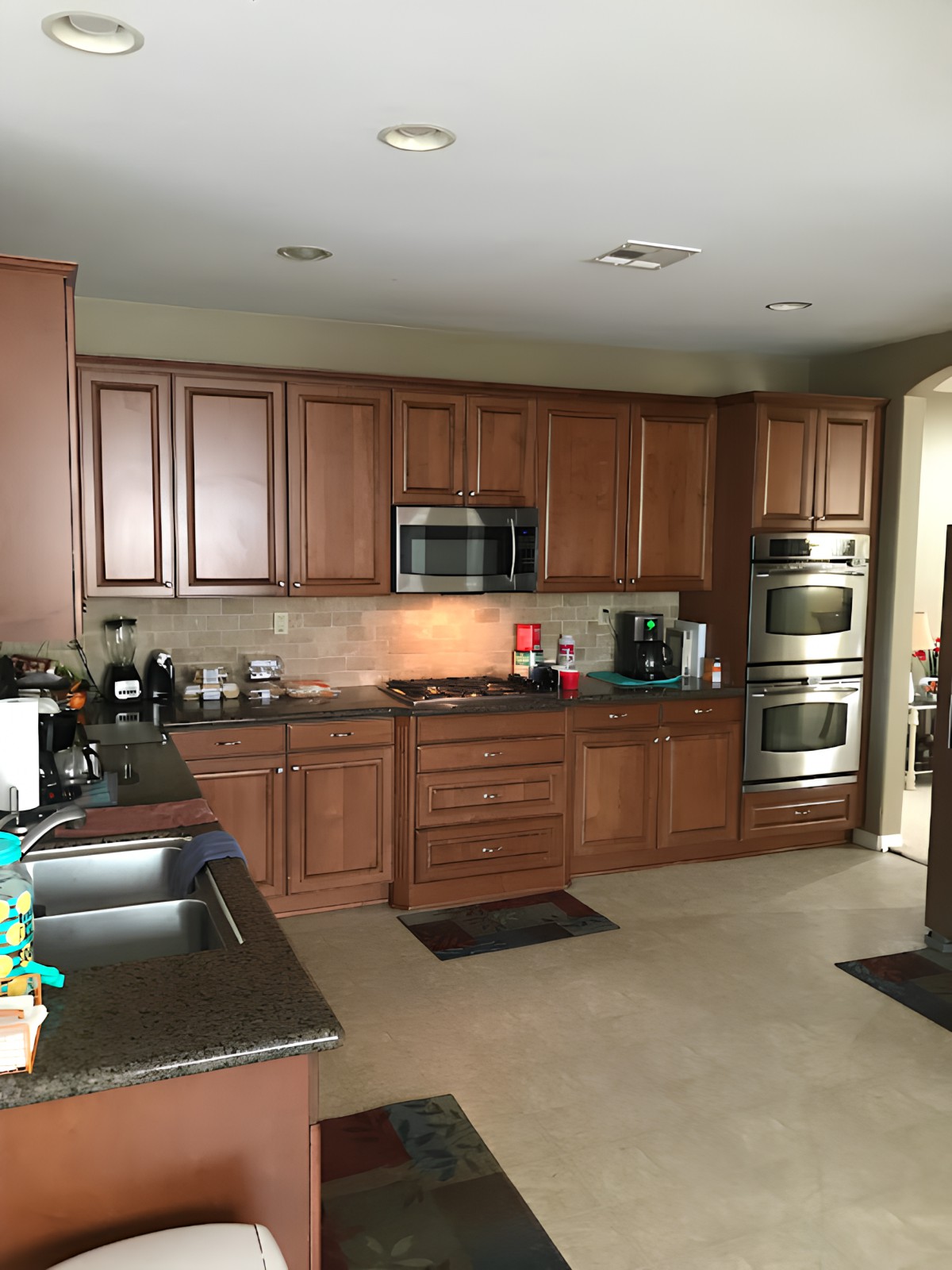 A modern kitchen with wooden cabinets and stainless steel appliances.