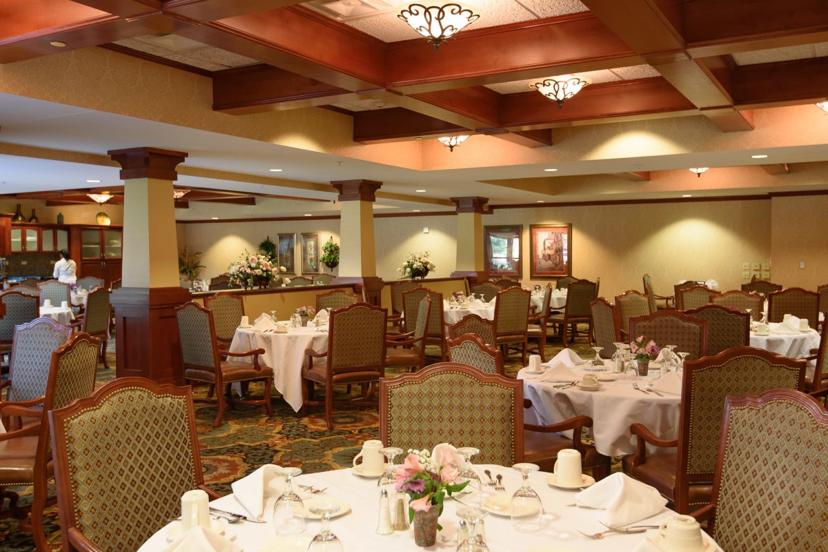 An elegant restaurant dining area with neatly arranged tables and chairs.