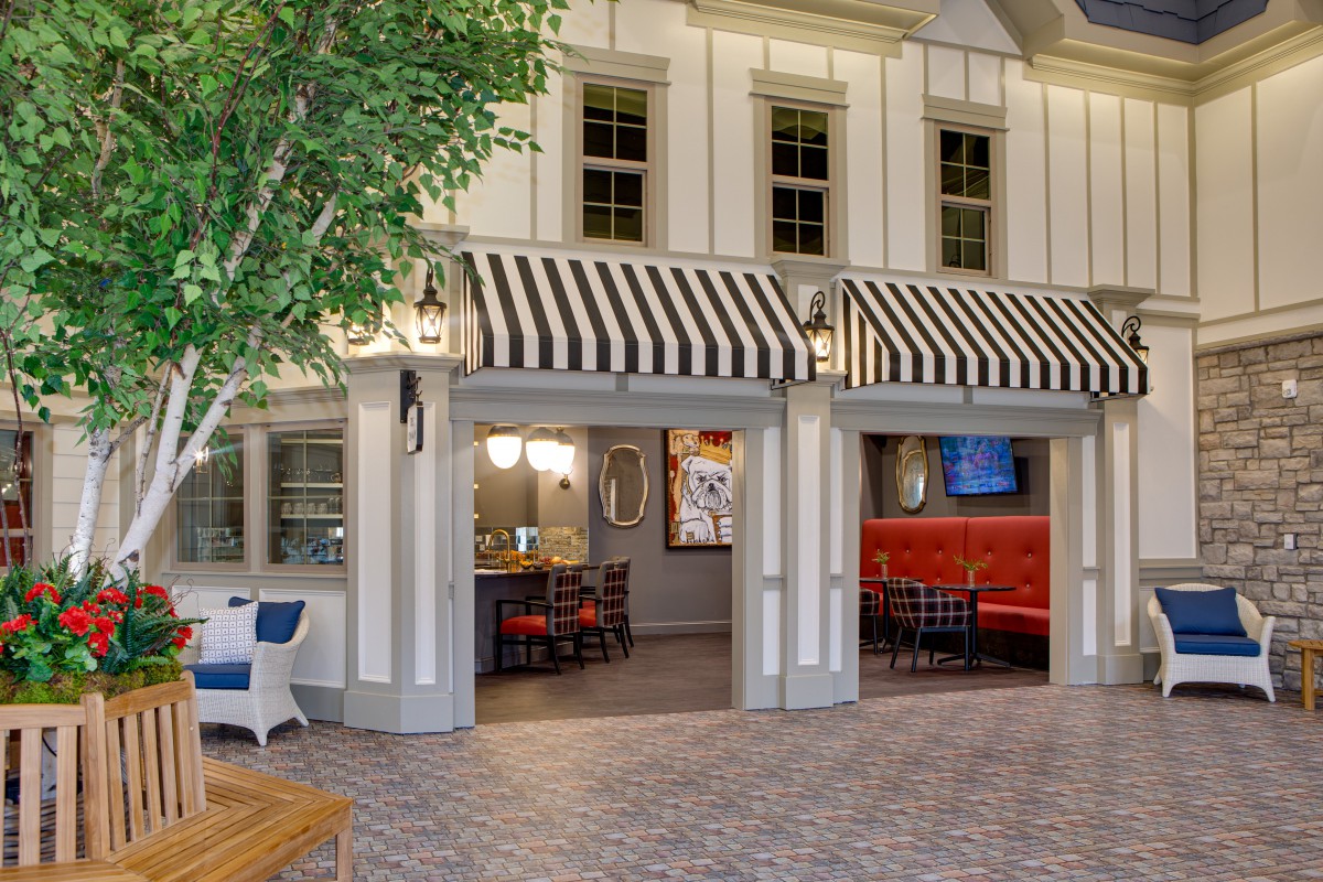 A cozy restaurant interior with striped awnings and a welcoming dining area.