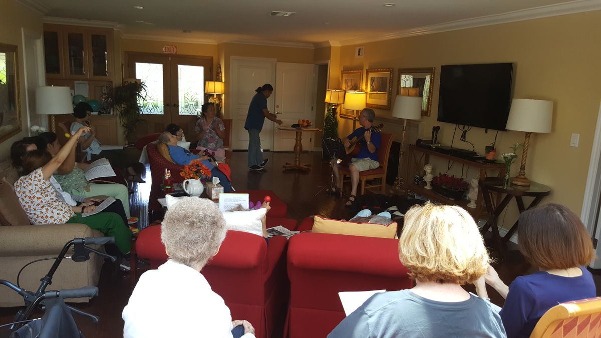 A group of people gathered in a cozy living room, enjoying an informal meeting.