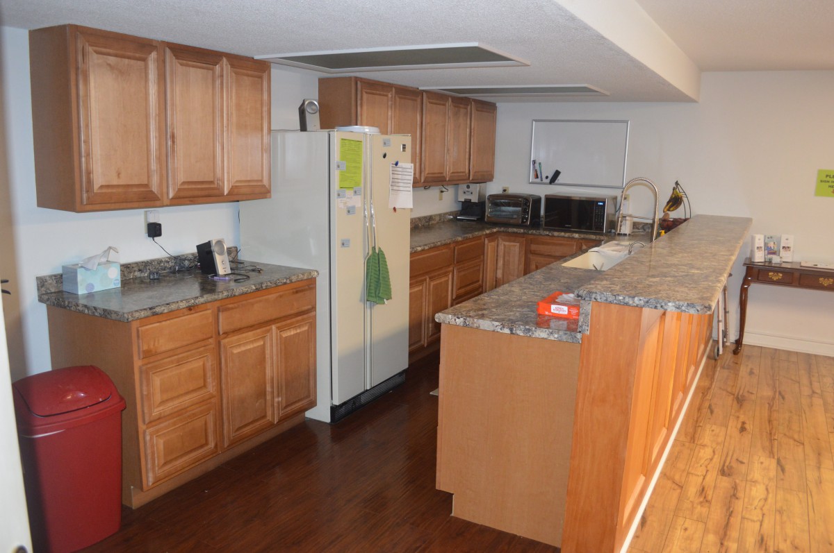 A spacious kitchen with wooden cabinets and modern appliances.
