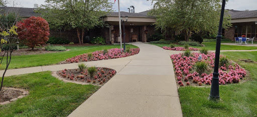 A picturesque walkway through a beautifully landscaped garden.