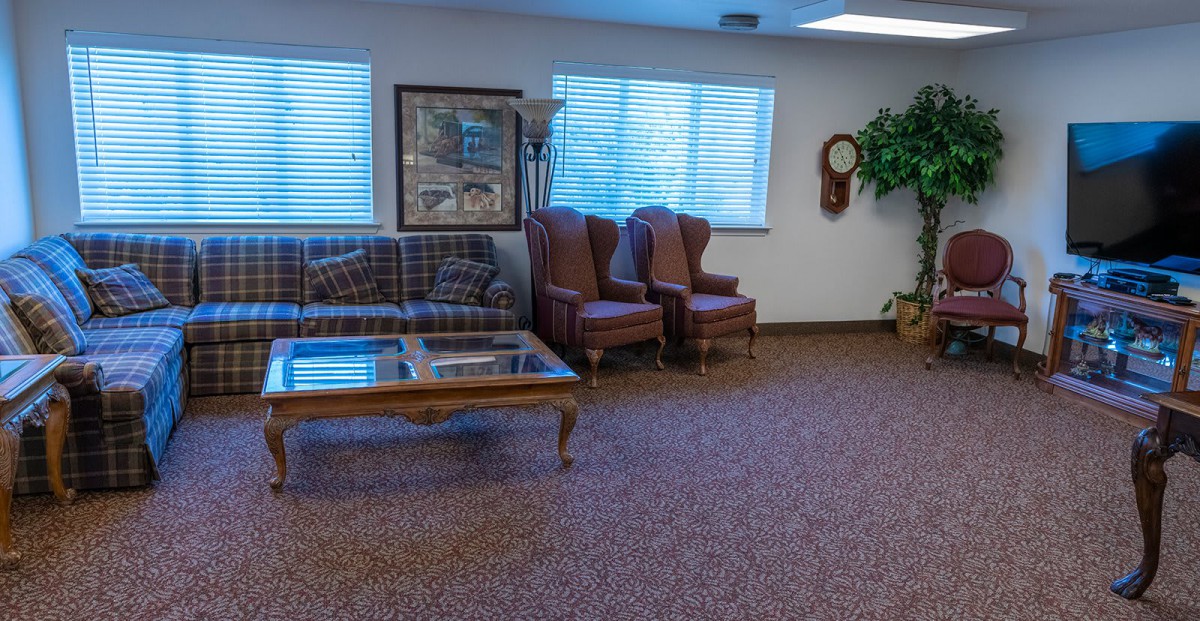 A cozy waiting room with comfortable seating and a coffee table.