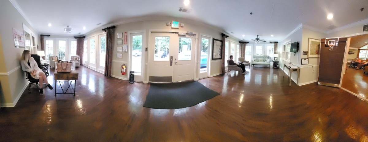 A spacious lobby area with a seating section and large windows.