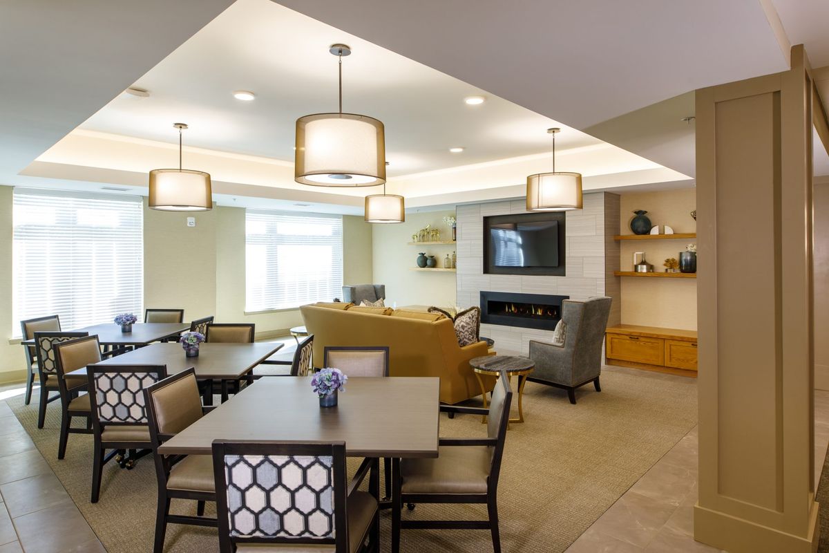 A modern, well-lit living and dining area with stylish decor and comfortable seating.