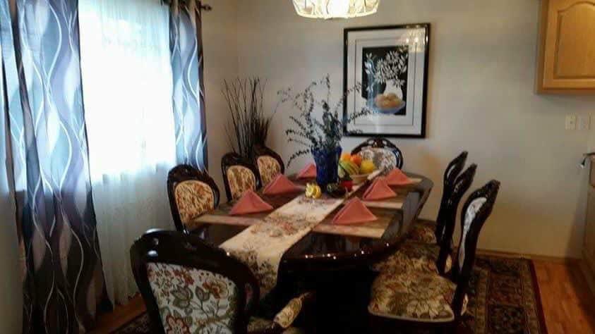 A beautifully set dining table with elegant decor and artwork.