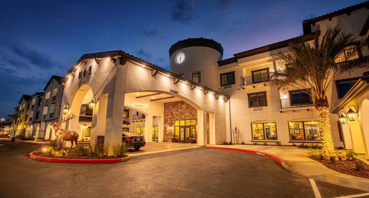 A beautifully illuminated hotel entrance at dusk.