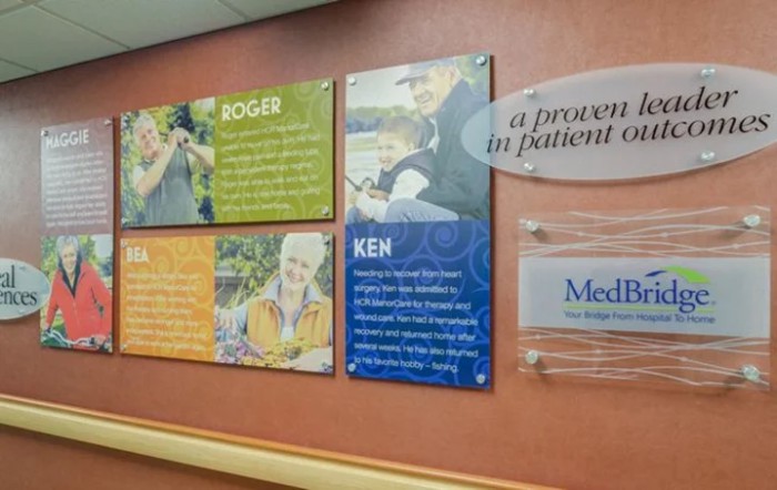 Hospital hallway featuring patient stories and testimonials displayed on the wall.