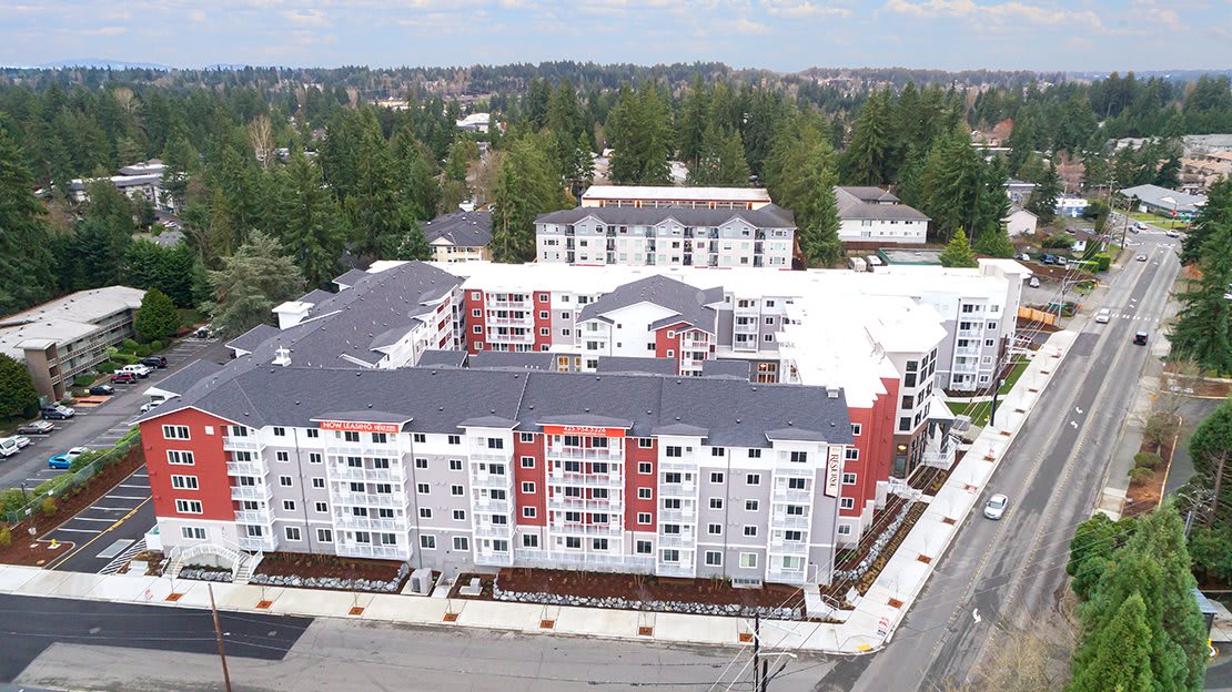 Aerial view of a modern apartment complex in an urban setting.
