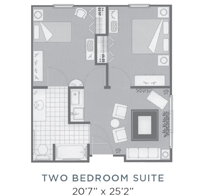 A floor plan showing a two-bedroom suite with distinct living, kitchen, and bathroom areas.