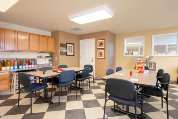 A well-organized conference room with tables and chairs arranged for meetings.