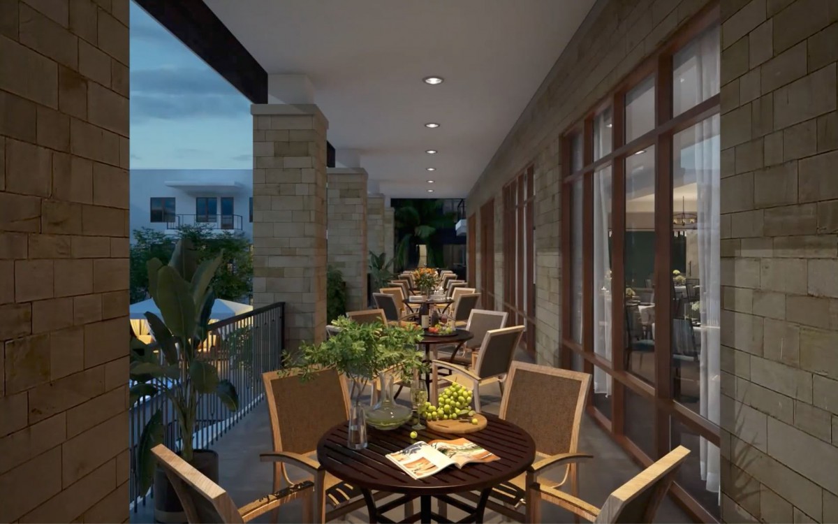 A cozy outdoor balcony dining area with tables and chairs, surrounded by plants in the evening ambiance.