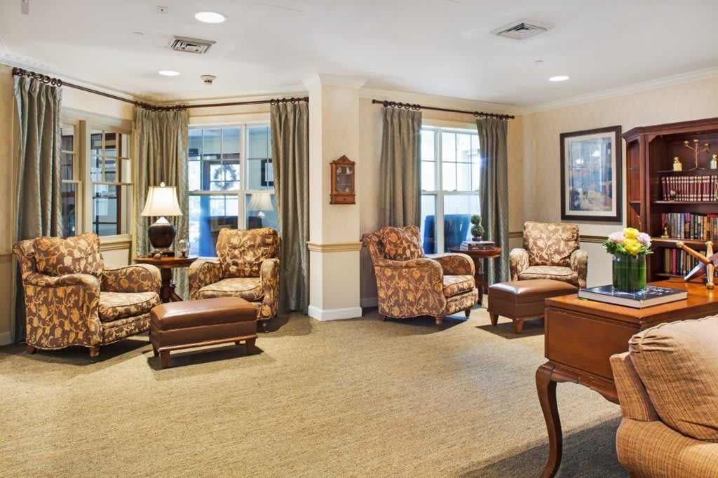 A cozy living room with comfortable armchairs and soft lighting.