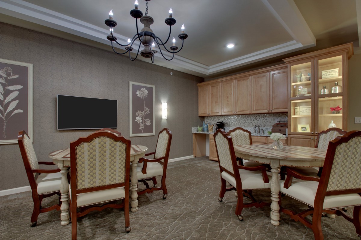 An elegant dining room featuring classic furniture and a sophisticated chandelier.