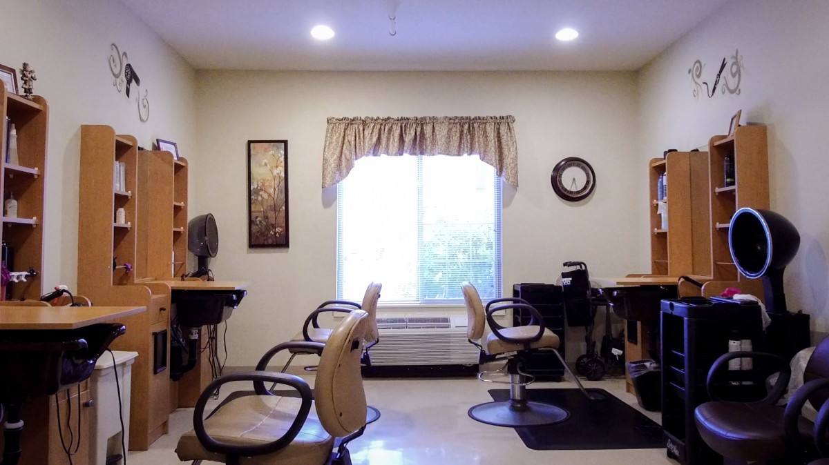 A cozy hair salon setup with two styling stations and natural light.