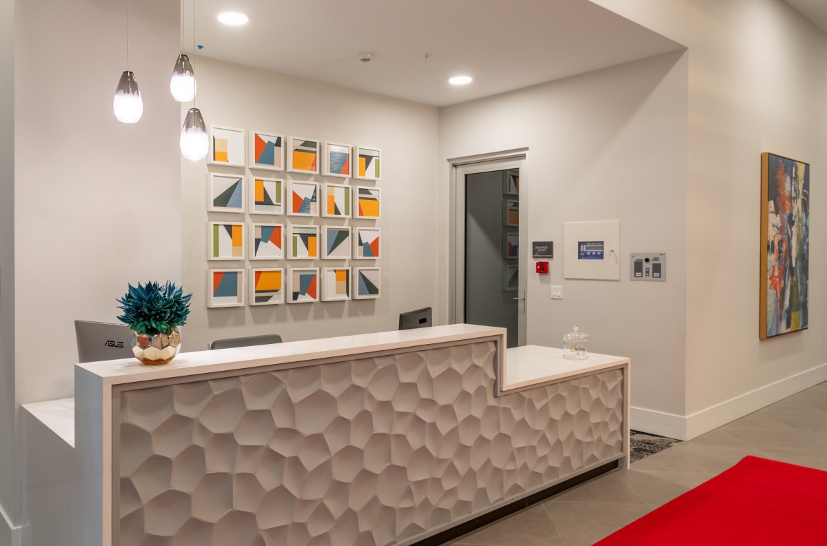A modern reception area featuring geometric decor and contemporary artwork on the wall.