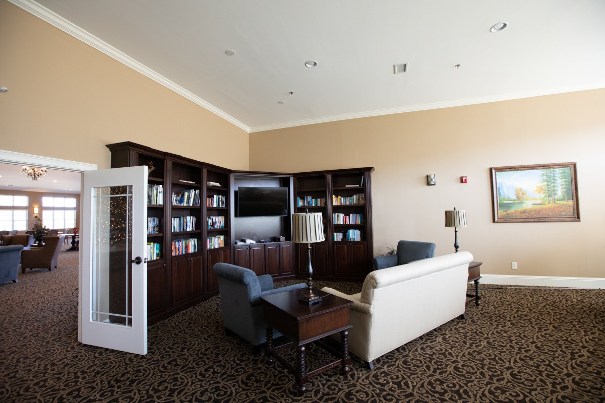 A cozy living room with bookshelves, a sofa, and a television.