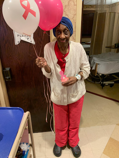 A joyful moment in the hospital as a resident celebrates with balloons.