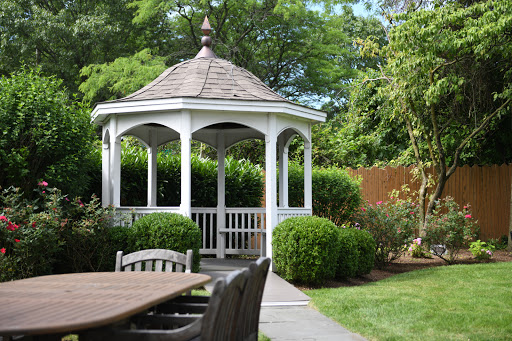A charming gazebo nestled in a lush garden, inviting relaxation and enjoyment of nature.