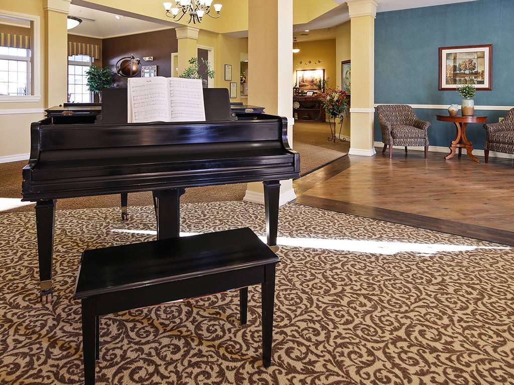 A grand piano situated in an elegant lobby with stylish decor.