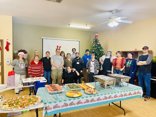 A cheerful gathering of friends and family celebrating the holiday season with a festive meal.