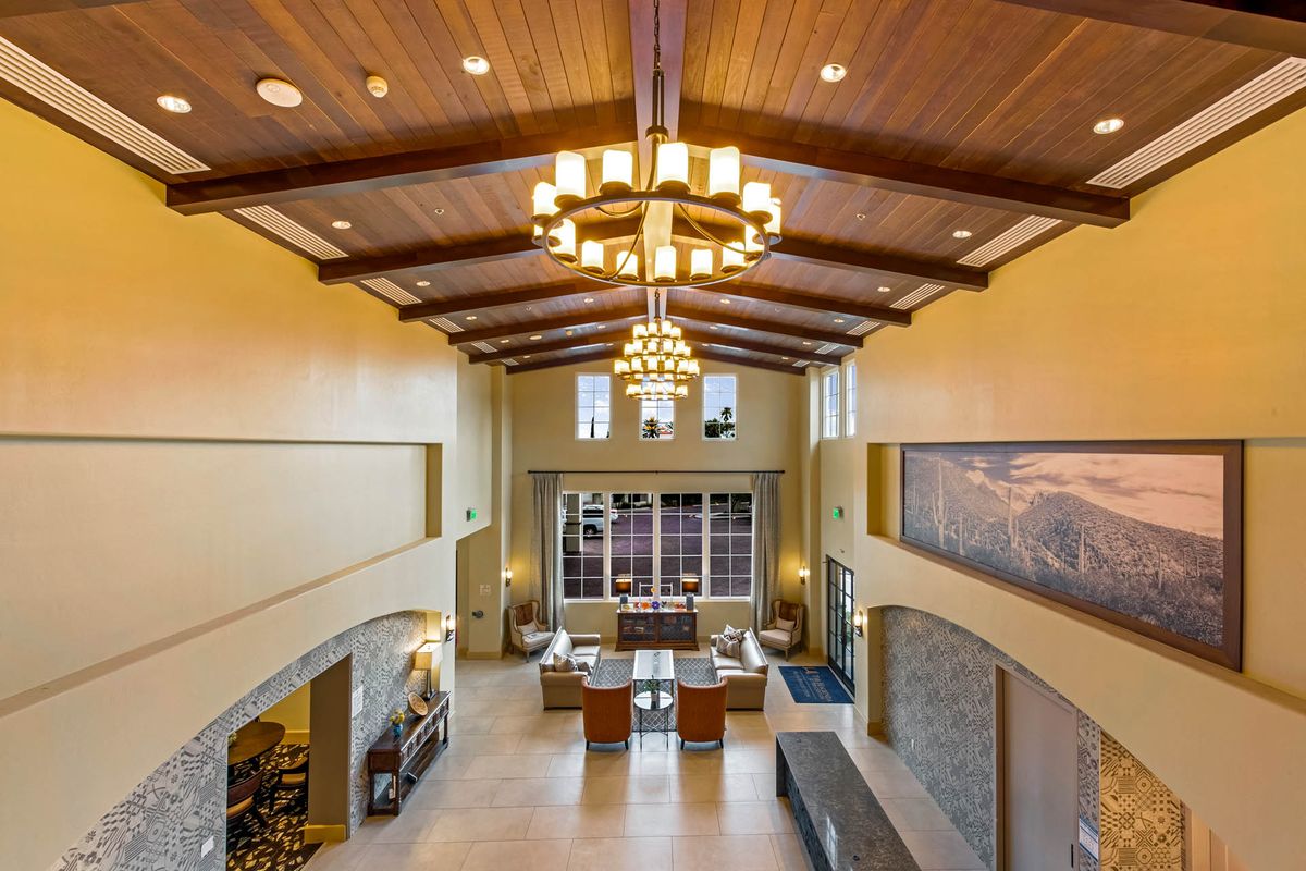 Spacious lobby with high ceilings and elegant chandeliers.