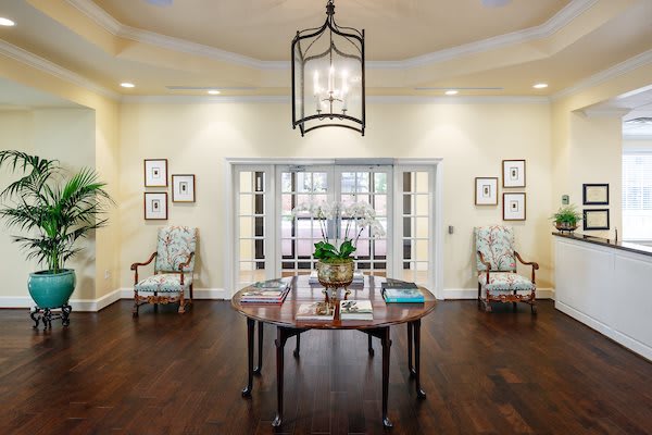 Elegant entryway with classic furniture and soft lighting.