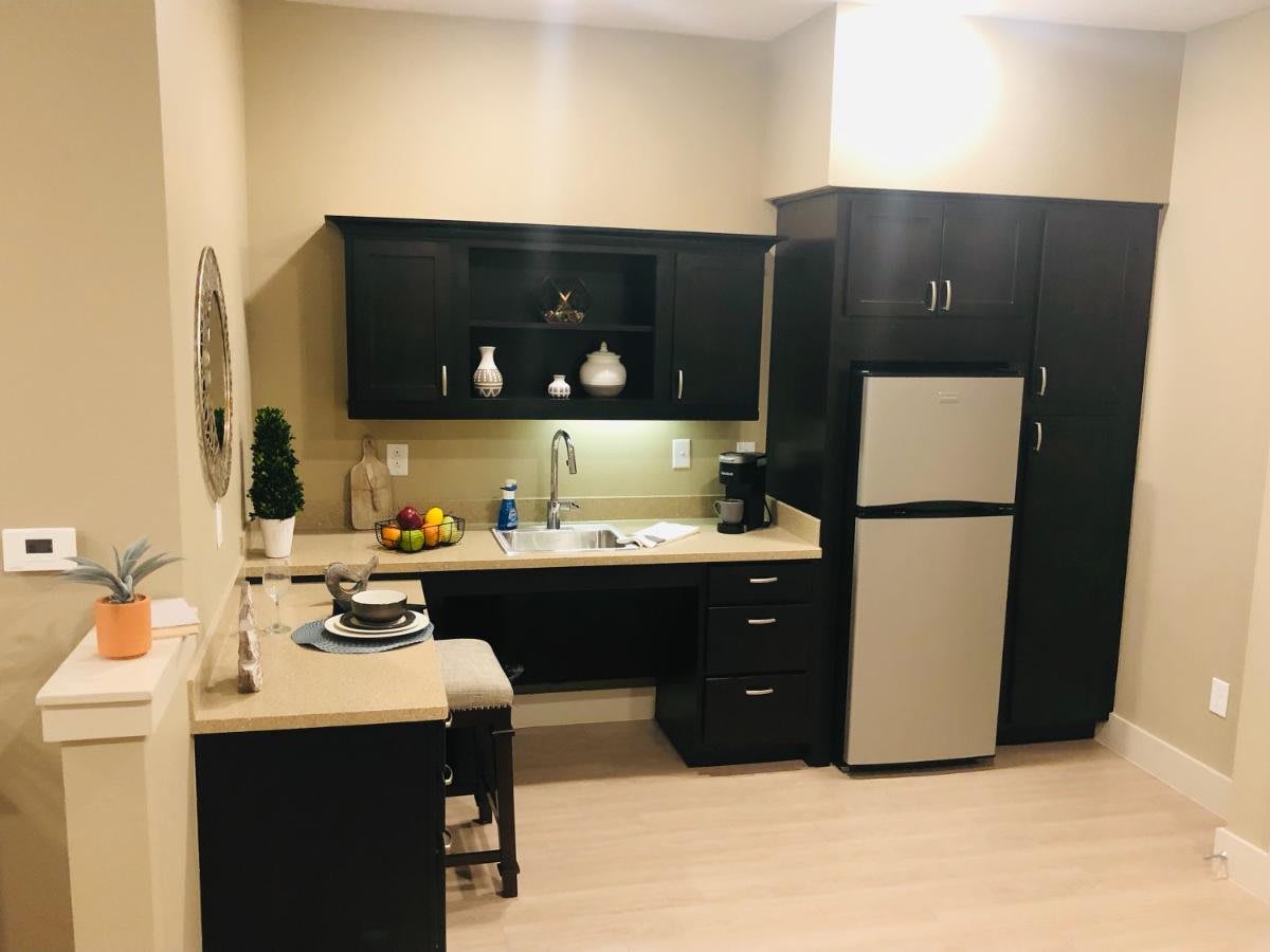 Modern apartment kitchen with sleek cabinetry and appliances.