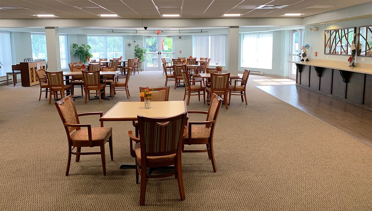 An empty dining area with neatly arranged tables and chairs.