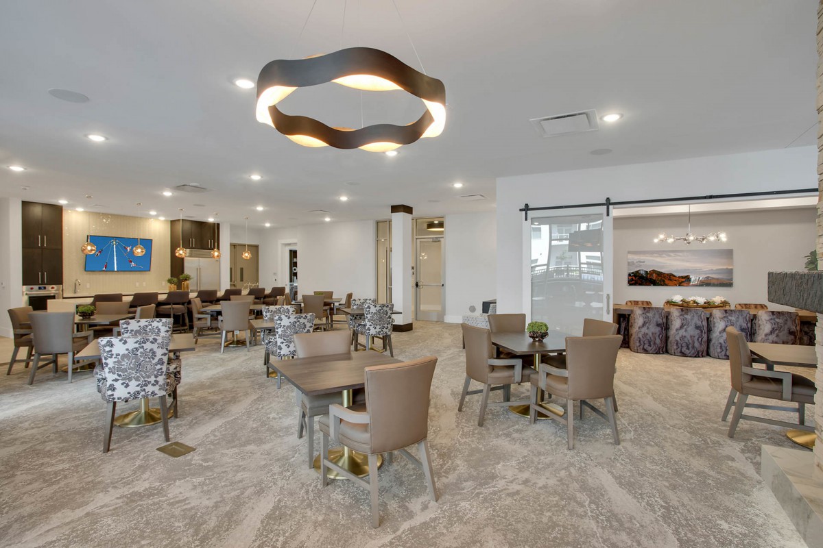 A modern interior with contemporary lighting and comfortable seating in a dining area.