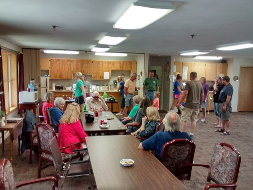 A lively gathering in a community space with people engaging and socializing.